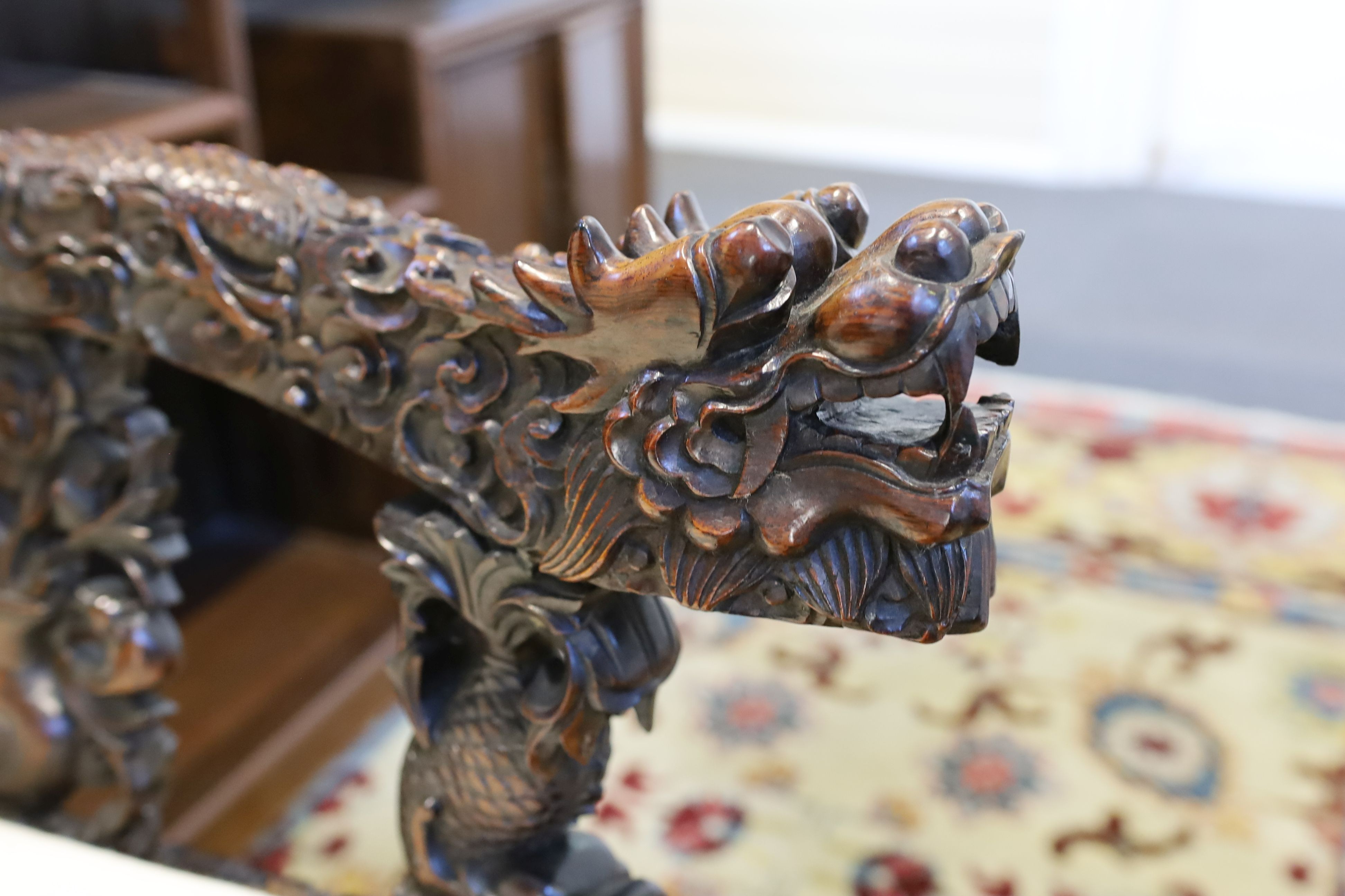 A good Chinese hardwood ‘dragon’ throne armchair, c.1900, 114.5cm high, 68cm wide at the arms